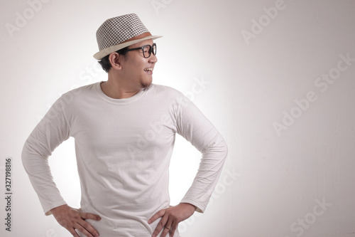 Young Asian Man Smiling Happily, Looking to the Side photo