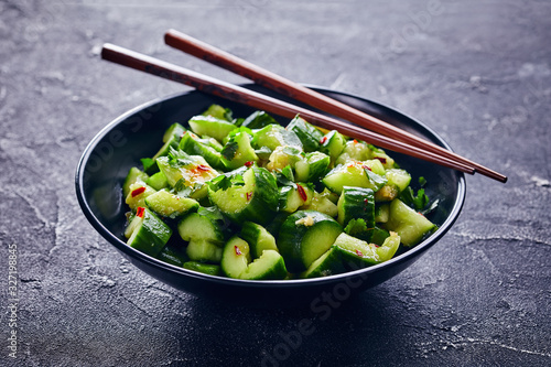 Chinese Smashed Cucumber salad in a black bowl