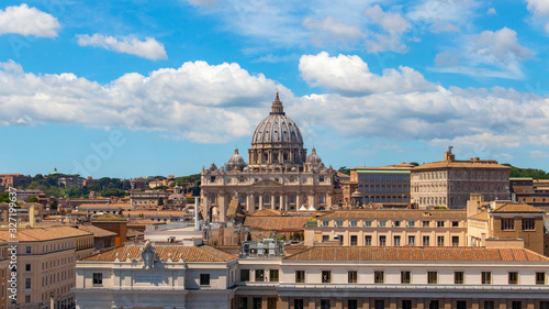 Beautiful aerial view on the St. Peter's Basilica ( Famous Roman landmark ) and ancient classical buildings of the Vatican on background of clouds. City of Rome. Italy. Europe