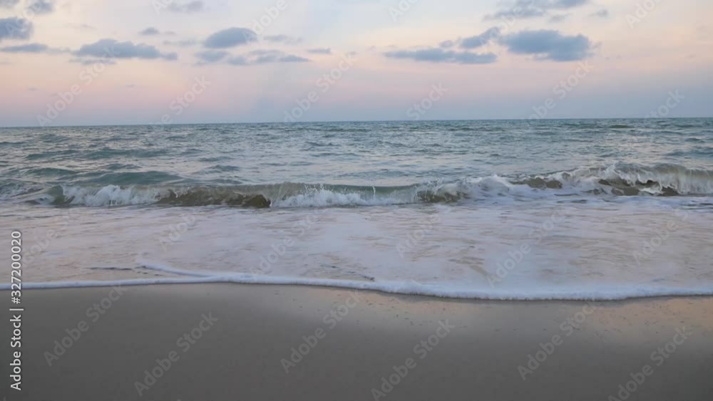 The waves in the sea lapping the white sand beach The waves in the sea lapping the white sand beach