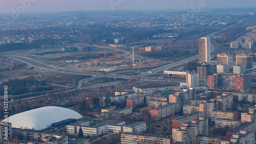 The view from the television tower to the city below. The areas of Vilnius. Buildings and streets. Vilnius TV tower. City at sunset. photo