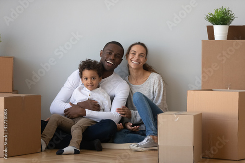 Portrait happy African American family with boxes in new apartment © fizkes