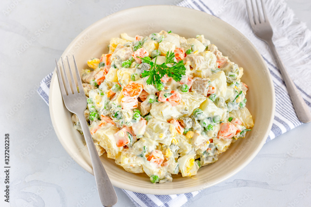 Traditional Russian salad Olivier in a Bowl Top View, White Background, Popular Russian Food Horizontal Stock Photo Traditional Russian salad Olivier in a Bowl Top View, White Background, Popular Russian Food Horizontal Stock Photo