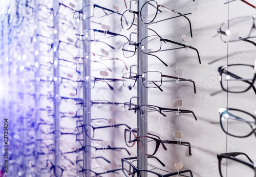 Row of luxury eyeglass at an opticians store. Gglasses background