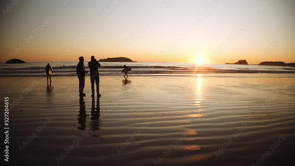 Tourists And Surfers Watching Sunset Over Sea Tourists And Surfers Watching Sunset Over Sea