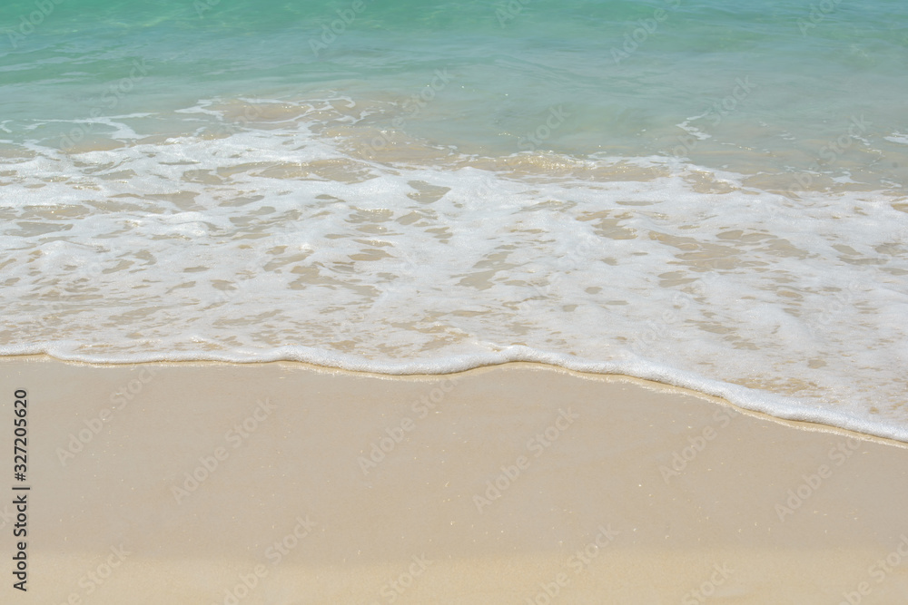 Beautiful fluffy sea waves on sandy beach. Blue crystal water. Fine, clean, white, sand like flour. Sunny Tropical seashore of Ko Rok Yai island, South Thailand, Andaman Sea. Summer nature background.