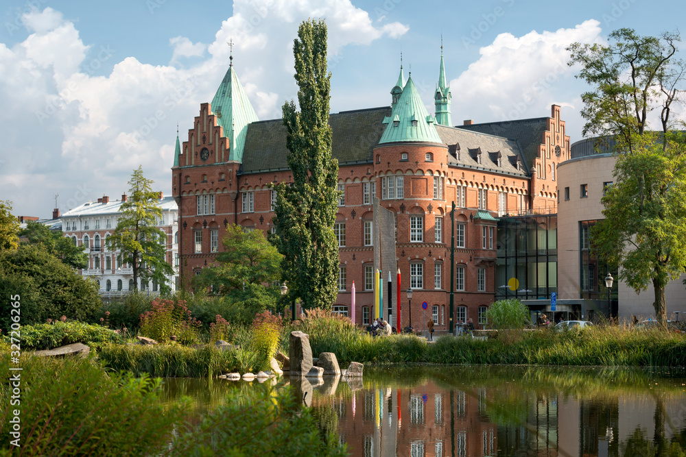 View of the city library in Malmo, Sweden. View with reflection of Malmo City Library, across the Lilla dammen lake.