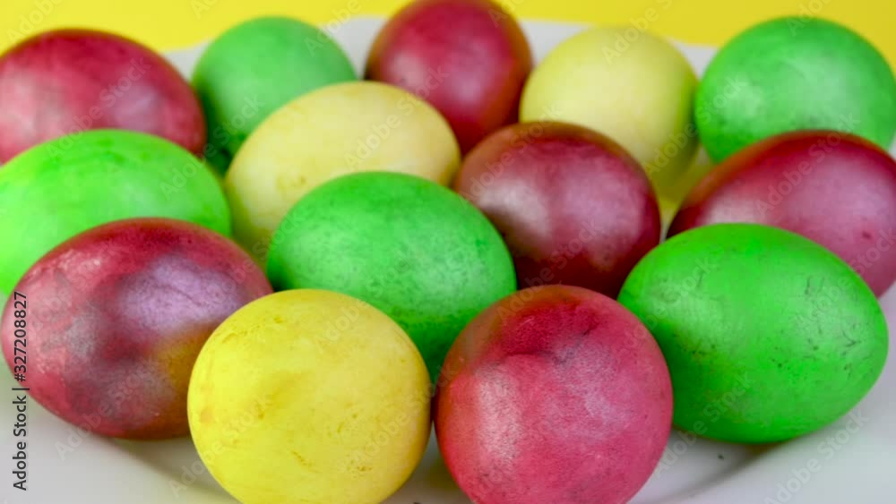 Closeup top view Colorful easter eggs lie on a plate. 360 rotation. Easter decorations. Easter concept background. Closeup top view Colorful easter eggs lie on a plate. 360 rotation. Easter decorations. Easter concept background.