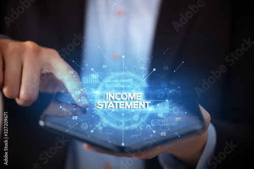 Businessman holding a foldable smartphone with INCOME STATEMENT inscription, new business concept