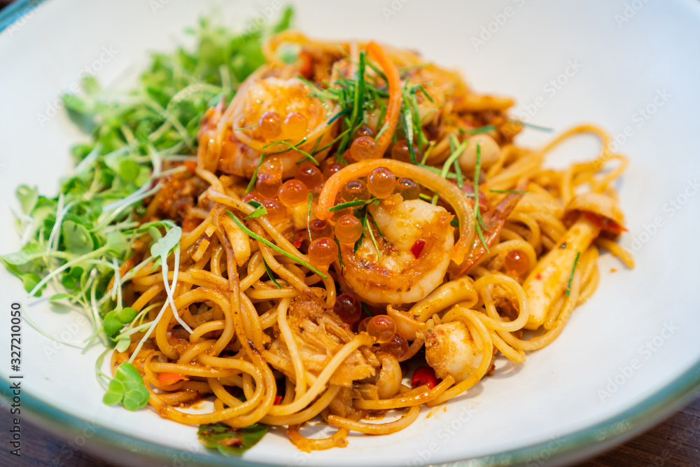 Tasty appetizing spaghetti pasta with prawns and salmon roe in Thai style. Tasty appetizing spaghetti pasta with prawns and salmon roe in Thai style.