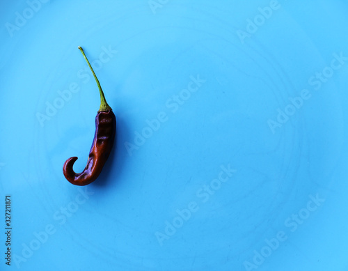 Chili pepper on blue plate