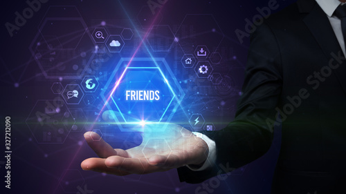 Wallpaper Mural Man hand holding FRIENDS inscription, social media concept Torontodigital.ca