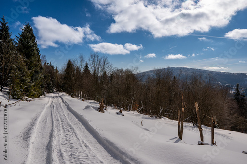 Fototapeta Naklejka Na Ścianę i Meble -  road in winter mountains rides cars and snow scooters, beautiful blue sky, slovakia beskidy, beskid mountains
