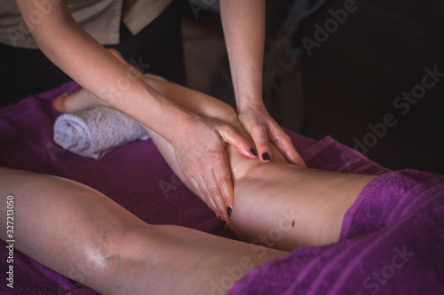 Therapist massaging human calf muscle