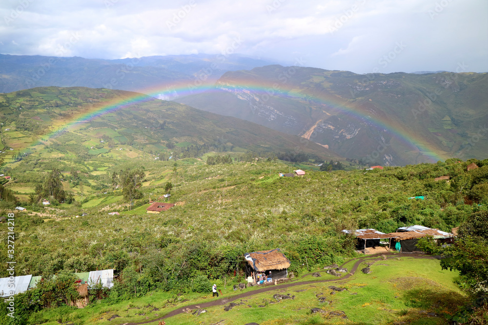 Amazing rainbow over the lower mountaintop village view from Kuelap ancient citadel in Amazonas region, northern Peru