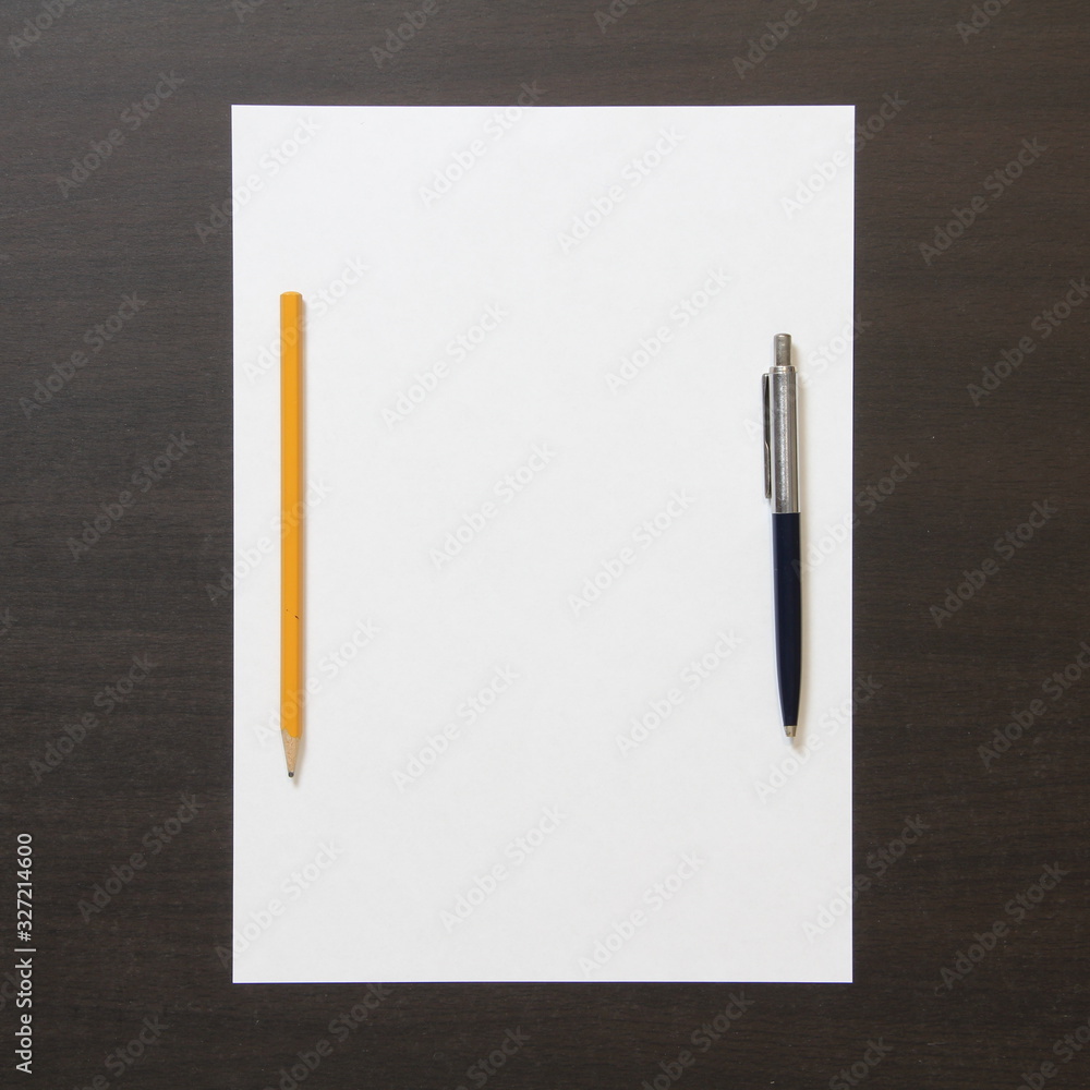 Template of white paper with pen and pencil on dark wenge color wooden background. Template of white paper with pen and pencil on dark wenge color wooden background.