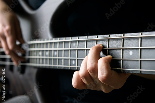 фотографія Bass guitar player hand closeup, lesson and practice theme
