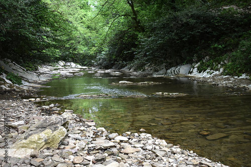 Beautiful background, mountain river and forest around. The river below the mountain Akhun. photo