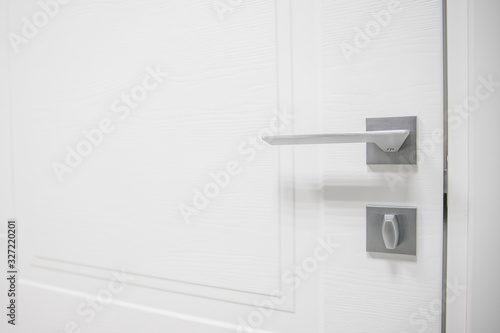Metal doors knob handle on modern interior