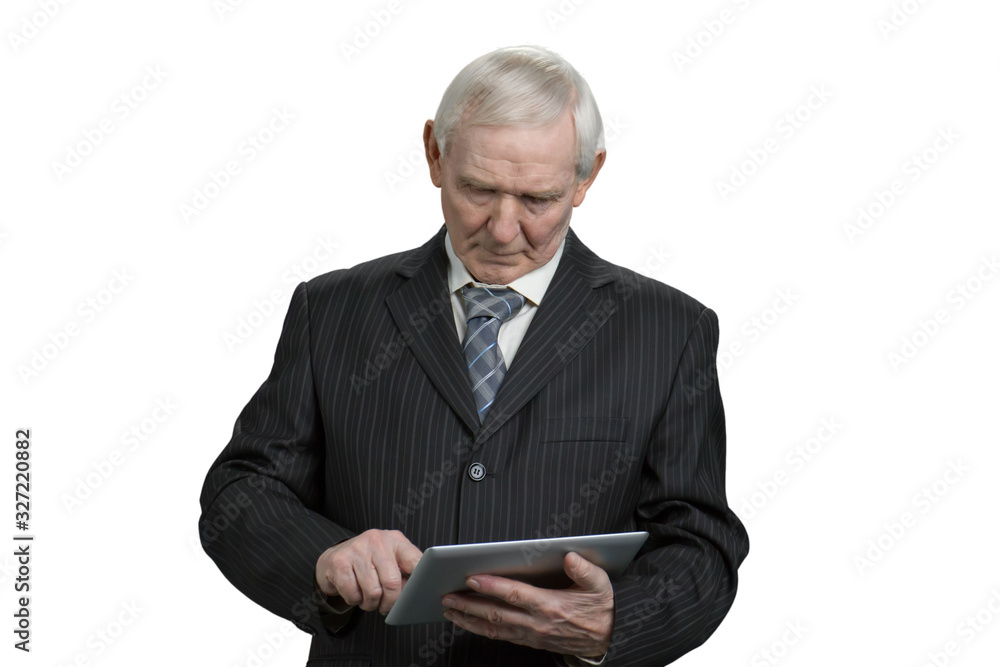 Old businessman using tablet. Senior man in suit tapping tablet gadget in white isolated background. Old businessman using tablet. Senior man in suit tapping tablet gadget in white isolated background.