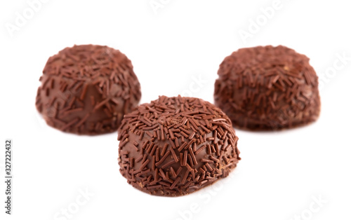 Three Milk Chocolate Truffles in a Row on a White Background