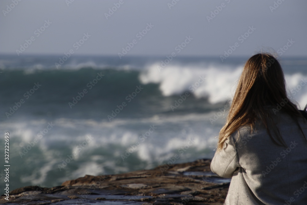 Girl staring at the waves