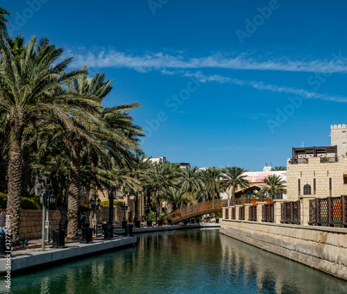 landscape  nature  clear  day  blue  sky  white  clouds  Sunny  light  channel  water  reflections  beach  palm trees  trees  bushes  buildings  structures  bridge  architecture  style  travel  leisur