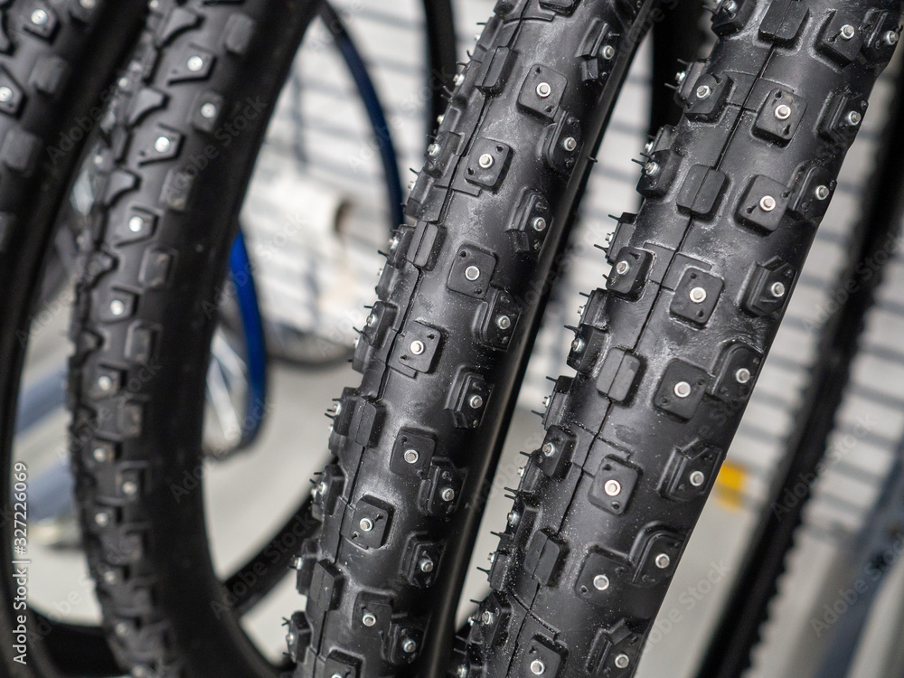 Fototapeta premium New bicycle tires close up in the sports store