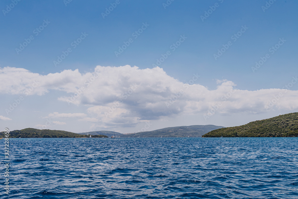 Greek Island viewed from the sea. Beautiful sea landscapes on Island in Greece. In distance is famous Scorpios island, from the left side is Lefkada island and from right is a part of gorgeous