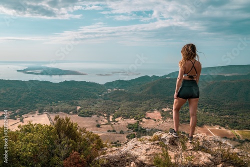 Woman overlooking the ocean and forest. © Yorick