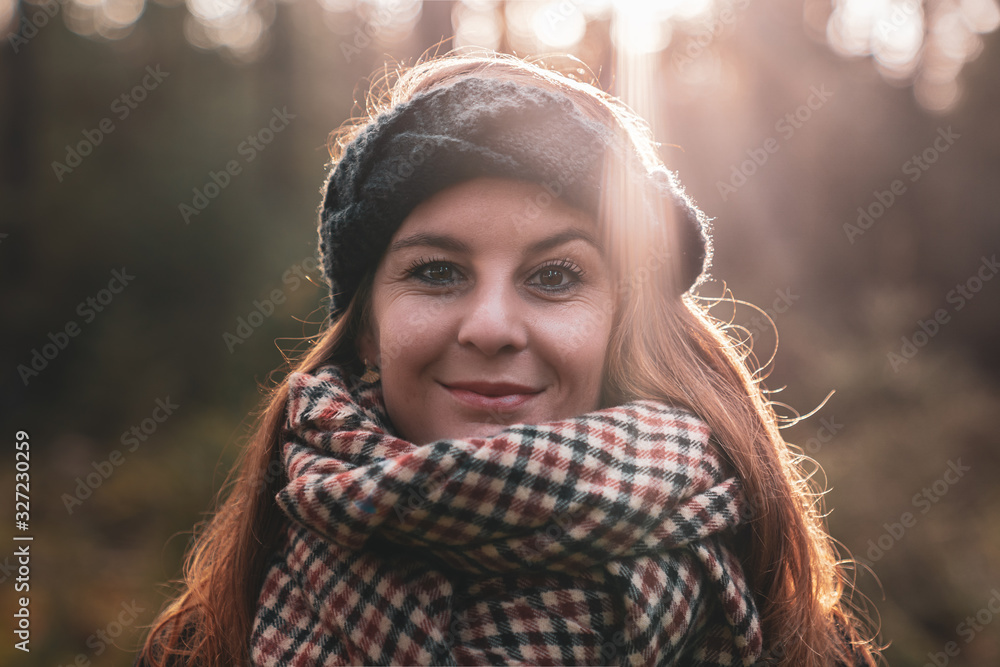 Woman standing in the sunshine under the cover of the forest. Woman standing in the sunshine under the cover of the forest.