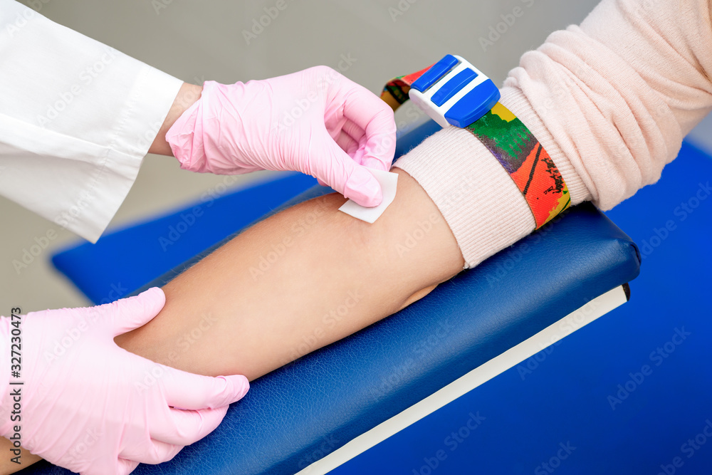 Disinfecting the arm skin by cotton before giving a injection vaccine Disinfecting the arm skin by cotton before giving a injection vaccine