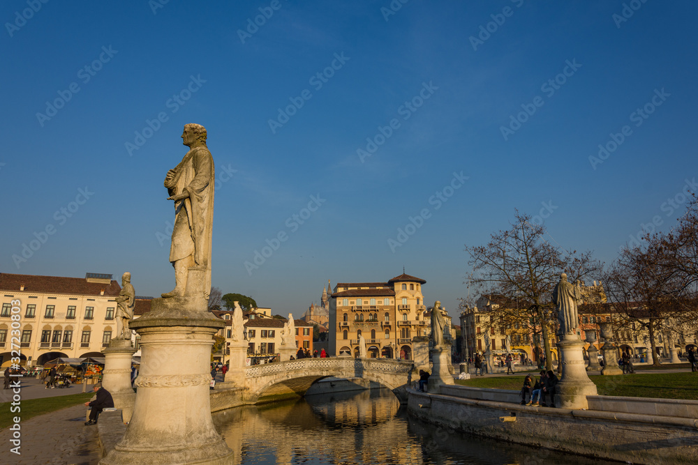 Statues at the largest square in the city of Padova known as Prato della Valle are reflected on the water of the canal