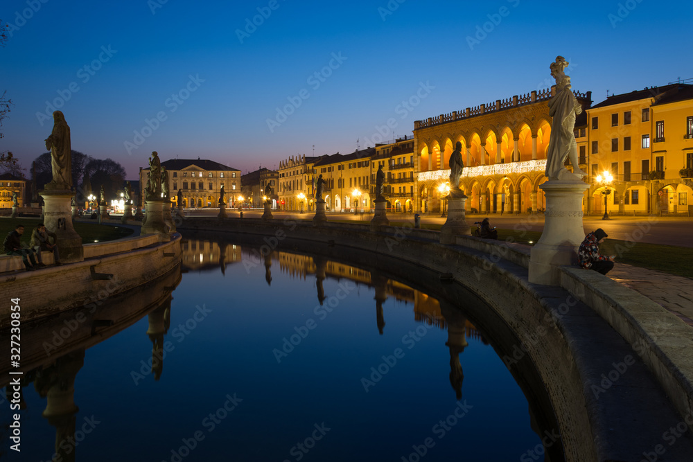 Statues at the largest square in the city of Padova known as Prato della Valle are reflected on the water of the canal