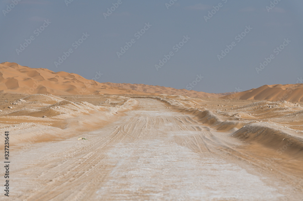 Dirt road among sand dunes in Oman