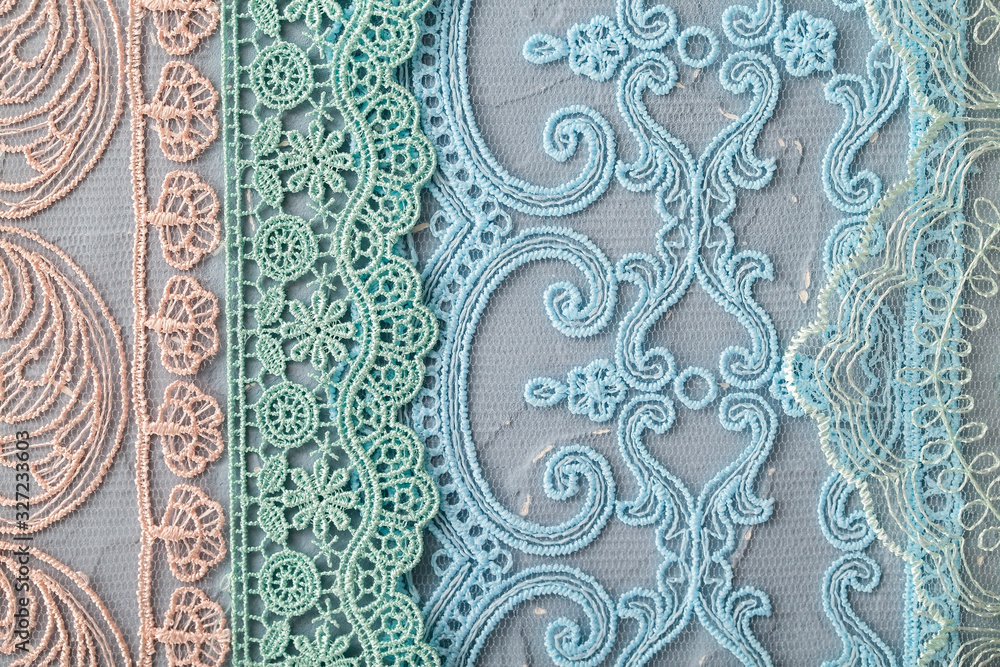 Fototapeta Beautiful laces on a shabby background, a textile product with an ornamental design, light transparent mesh patterned fabric