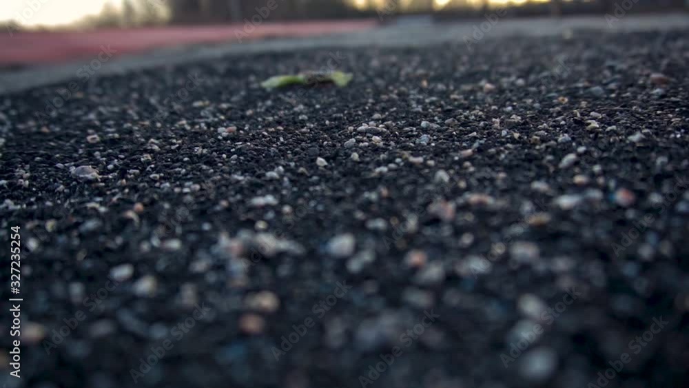 asphalt treadmill close up at sunset asphalt treadmill close up at sunset