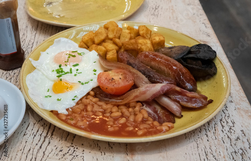 A hearty full English breakfast on a table.