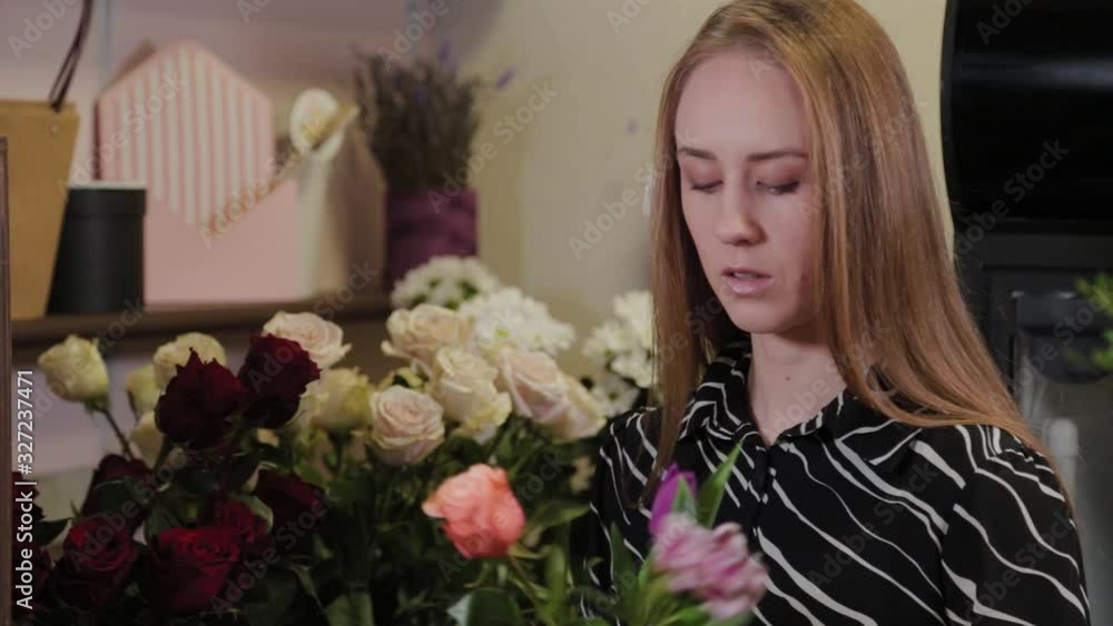 Professional florist collects a composition of flowers. Beautiful bouquet for International Women's Day. Professional florist collects a composition of flowers. Beautiful bouquet for International Women's Day.