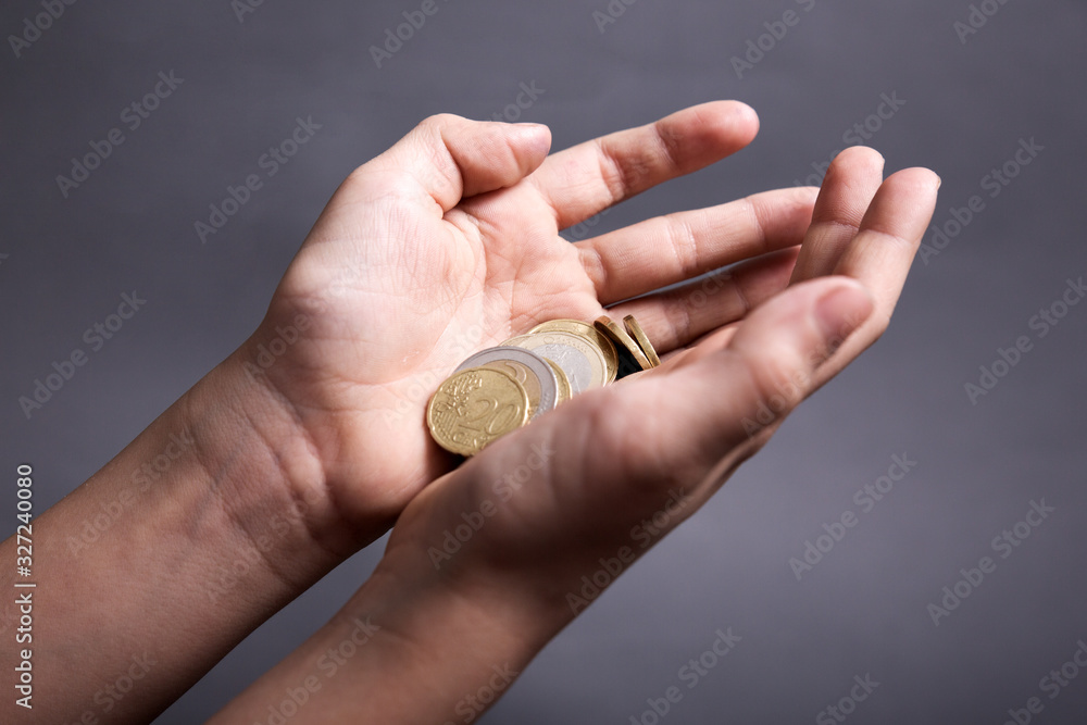 child hold in his little hands money euro on grey background child hold in his little hands money euro on grey background