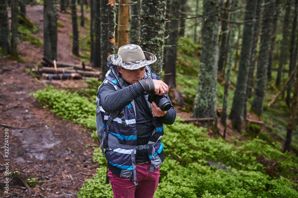 Photographer taking photos using digital SLR camera in natural outdoor Photographer taking photos using digital SLR camera in natural outdoor