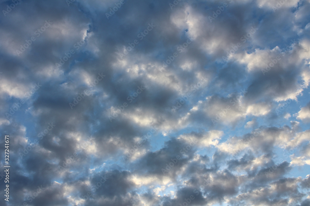 Obraz premium Clouds illuminated by the morning against the blue sky.