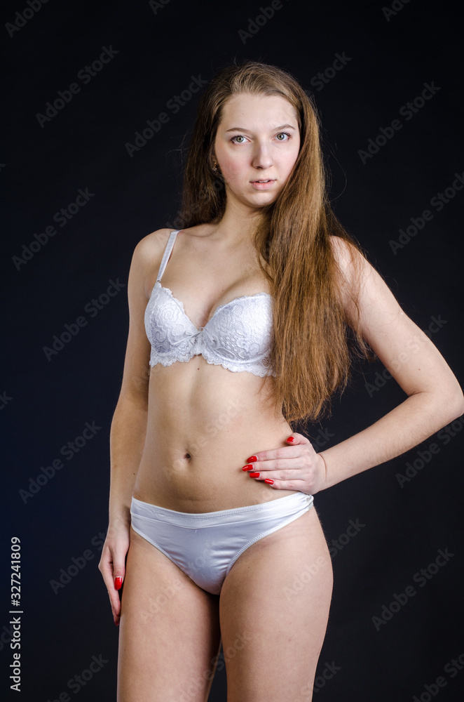 Obraz premium Sexy girl in lingerie on black background studio