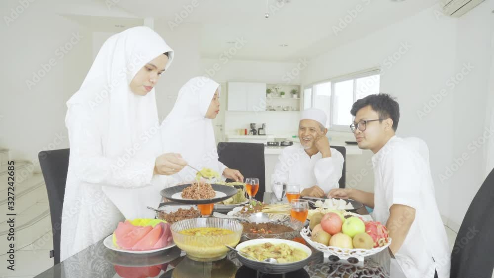 Happy Muslim family having lunch at Eid celebration Happy Muslim family having lunch at Eid celebration