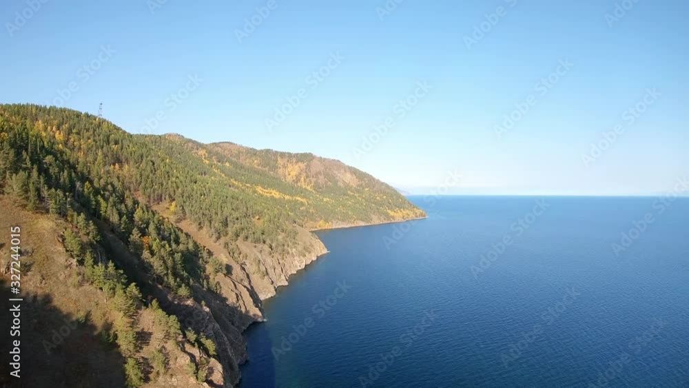Flight above the high steep rocky shore of the sea. Aerial shot. Lake Baikal Flight above the high steep rocky shore of the sea. Aerial shot. Lake Baikal