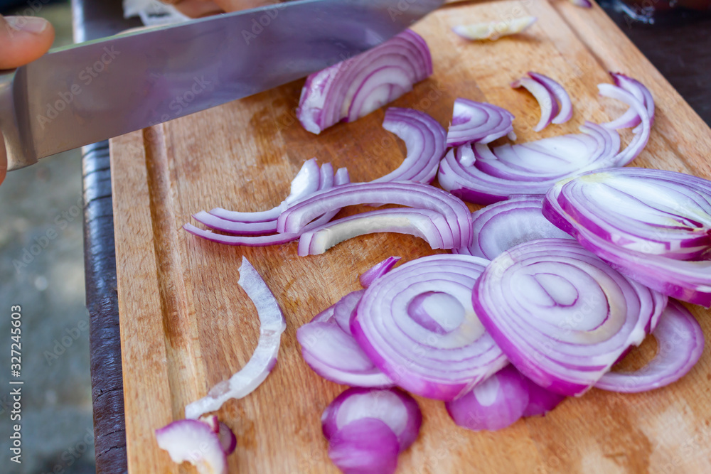 red onion cut on a wooden cutting board outdoor picnic red onion cut on a wooden cutting board outdoor picnic