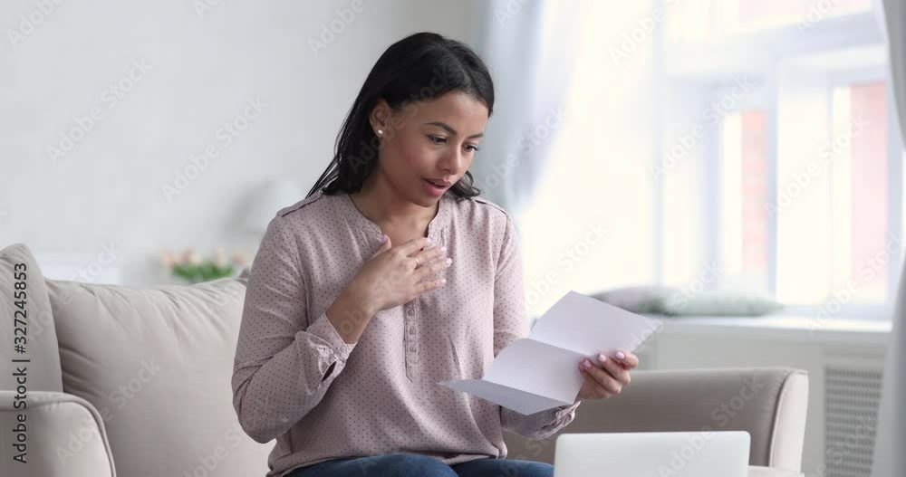 Excited african lady feel glad receive good news in letter Excited african lady feel glad receive good news in letter