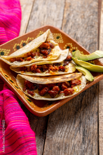 Mexican quesadillas with chorizo on wooden background photo