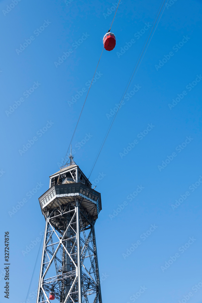 Steel tower of the cableway air transport system in Barcelona Spain with Red Cabin seen from below Steel tower of the cableway air transport system in Barcelona Spain with Red Cabin seen from below