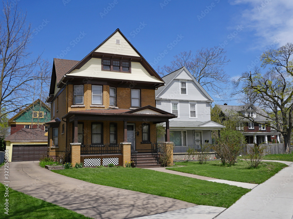 street with large older detached brick and clapboard houses with gables street with large older detached brick and clapboard houses with gables